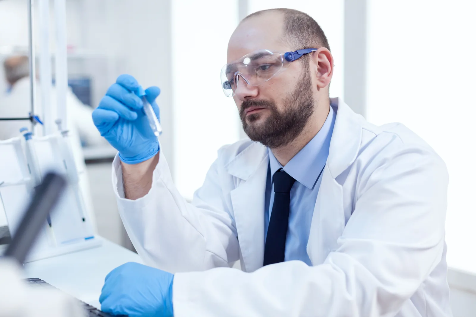 Laboratory technician examining a sample vial